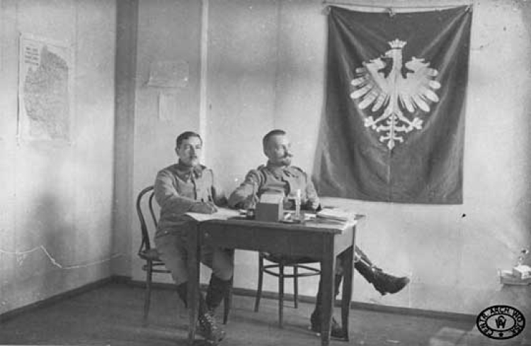 Zastępca szefa Departamentu Wojskowego Naczelnego Komitetu Narodowego dr Wacław Tokarz (drugi od lewej) w swoim biurze. 1915 r.