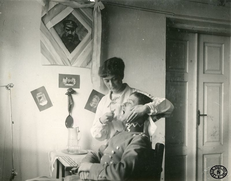 Sanitariuszka przy pracy w gabinecie dentystycznym. Pozycje nad Styrem, Wołyń. Wiosna 1917 r. Źródło: CAW